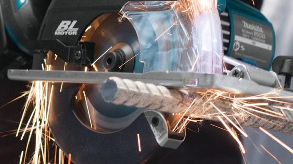 A circular saw cutting through a piece of rebar.